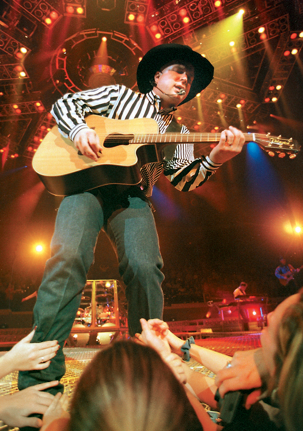 Garth Brooks playing guitar at concert 