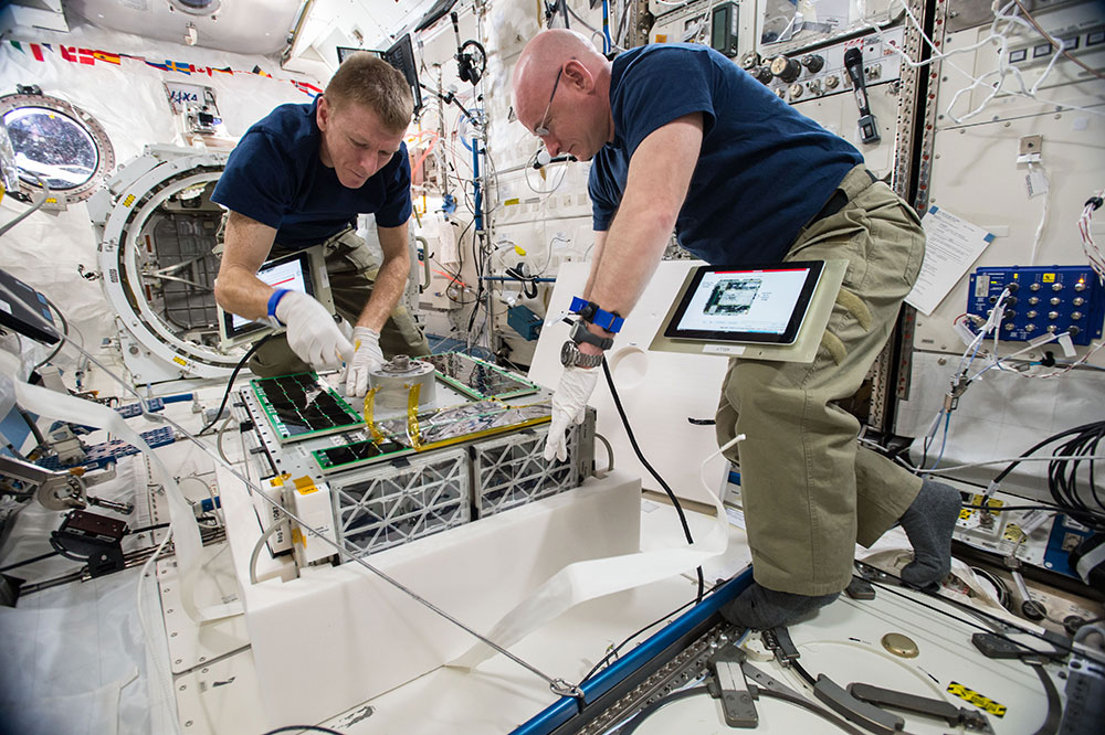 astronauts working inside of shuttle